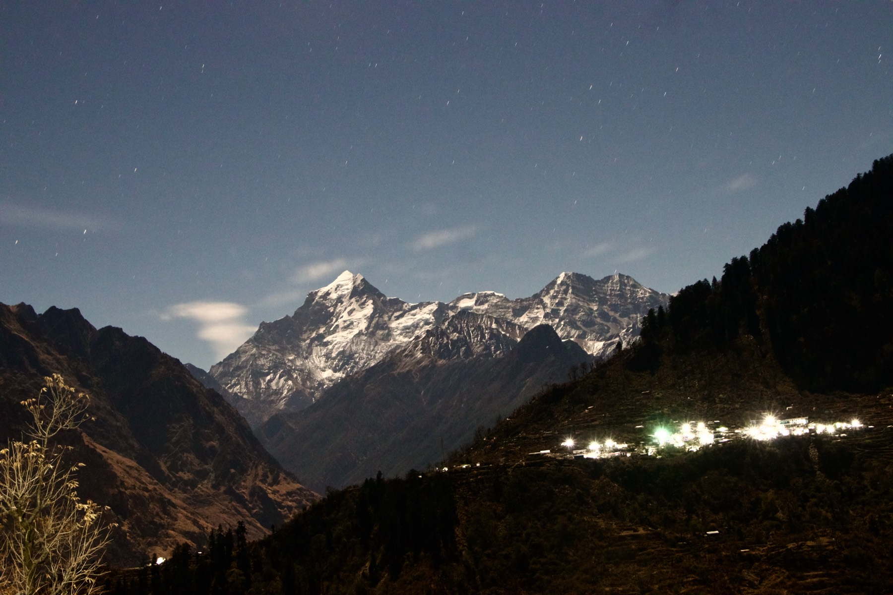 Snow peaks and a lit village at night, Kuari Pass